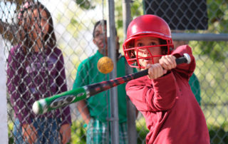 Child batting at Murrieta family attraction with pitching cages