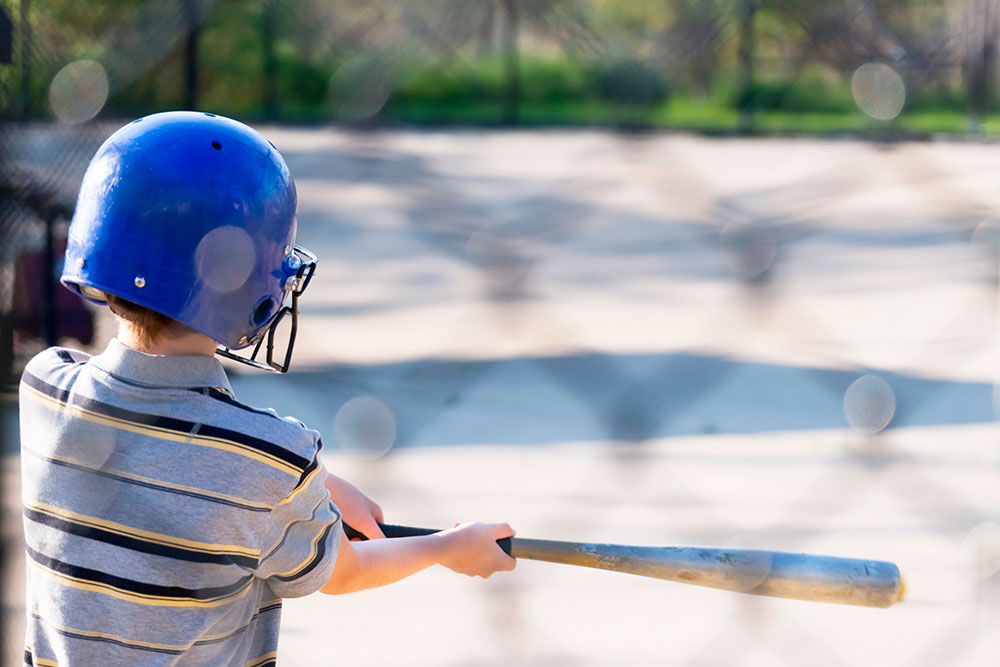 Young player practicing swings at kids batting cages in Temecula ,CA