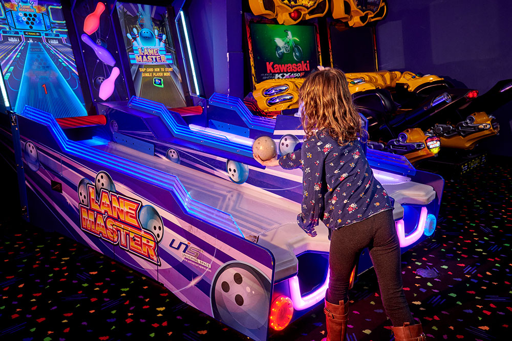 Child enjoying skee-ball at Mulligan Family Fun Center arcade in Murrieta