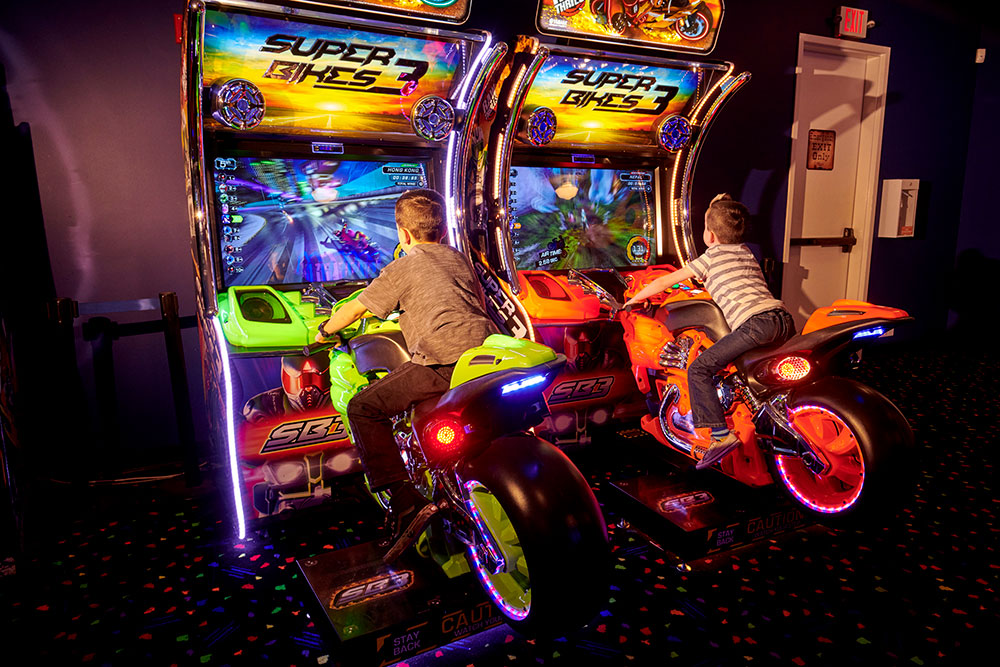 Kids riding arcade bikes at Mulligan Family Fun Center in Murrieta