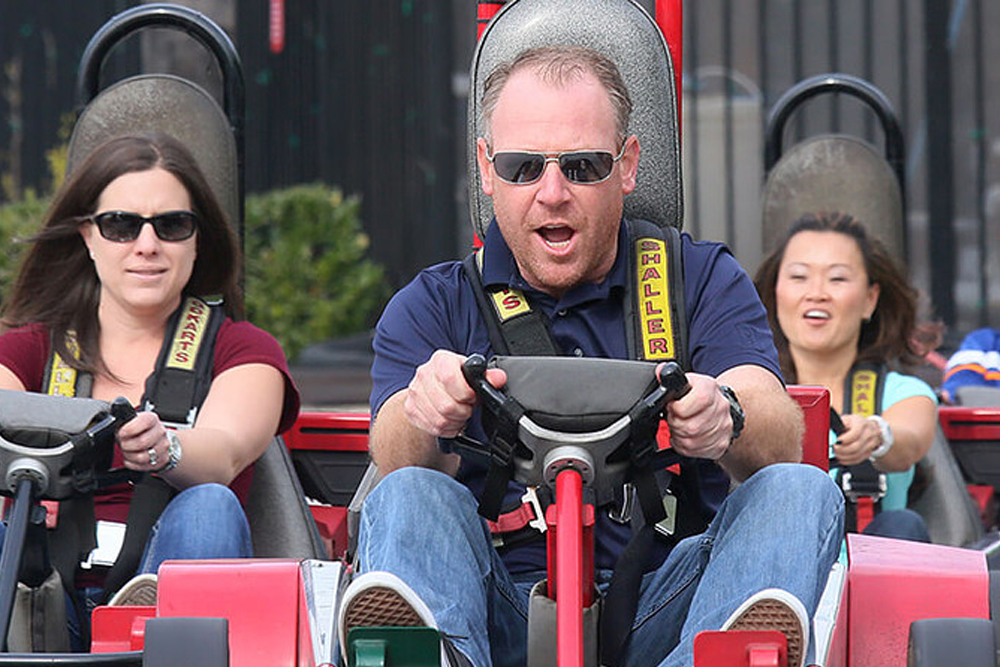 Adults enjoying go-kart racing at Mulligan Family Fun Center as part of their group packages experience