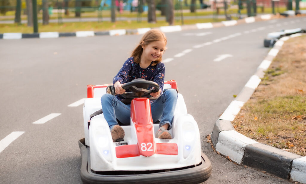 Child racing go-karts at a family amusement center in California