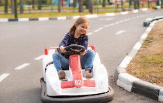 Child racing go-karts at a family amusement center in California